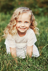 Little girl holds a dandelion and sneezes. Medical concept.