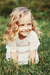 Little girl running on meadow with sunset