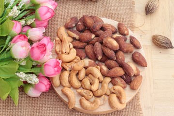 Almonds and cashew is delicious on wood background.