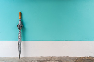 umbrella on cement floor with pastel wall background, vintage