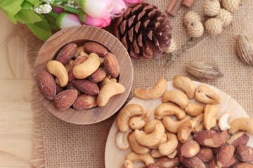 Almonds and cashew is delicious on wood background.