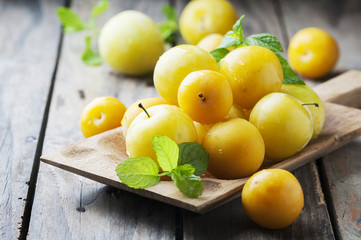 Summer sweet yellow plums on the wooden table