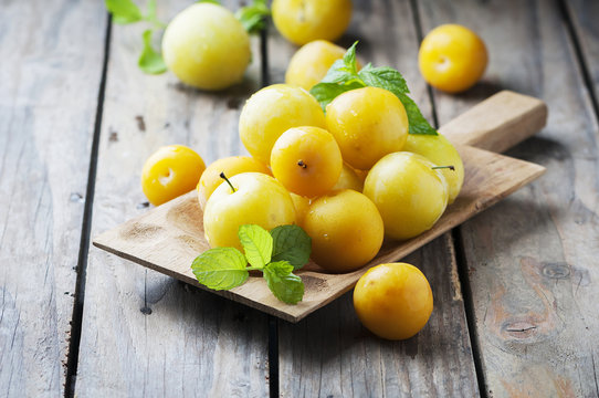 Summer sweet yellow plums on the wooden table