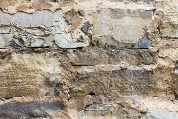 old wall masonry with different sizes smeared joints