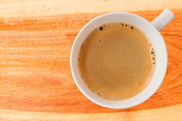 Hot coffee cup with clipping path top view on wood plank backgro
