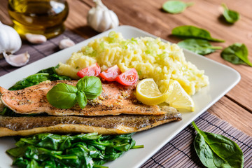 Baked trout fillet with mashed potatoes and steamed spinach