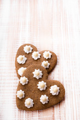 Heart shaped cookies on white wooden background