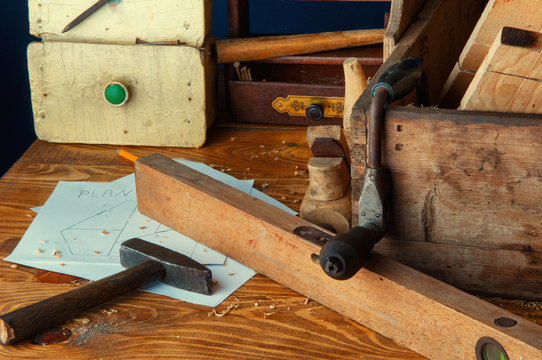 Equipment carpenter on a wooden desk with plans