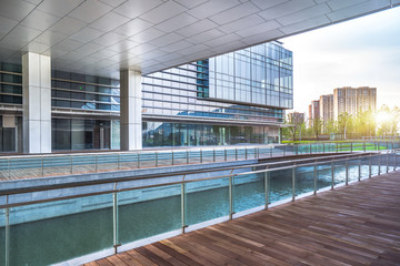 Empty wooden footpath front modern building