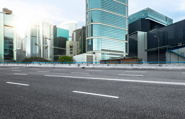 city empty traffic road with cityscape in background