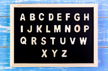 Wooden english alphabet A-Z on the blackboard.