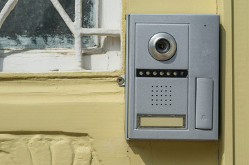 Closeup shot of a intercom on a old wooden door
