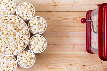 Bowls of fresh popcorn alongside a machine