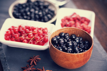 Berry fruits in bowls and dishes