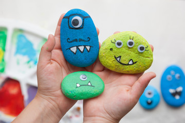 Child holding stone monster family craft © ISO101