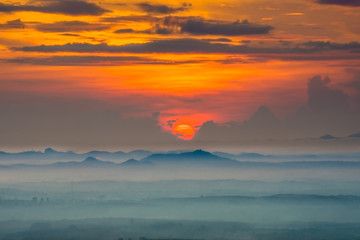 Sunrise and blue mountain with mist.