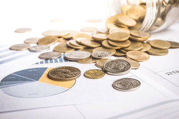 Coins on paper graph chart background.For business and financial
