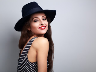 Happy bright makeup woman in fashion black hat and red lips posi