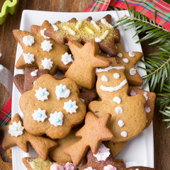 Colorful Christmas gingerbread cookies on wooden background