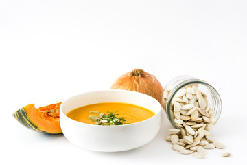 Pumpkin soup and ingredients isolated on white background

