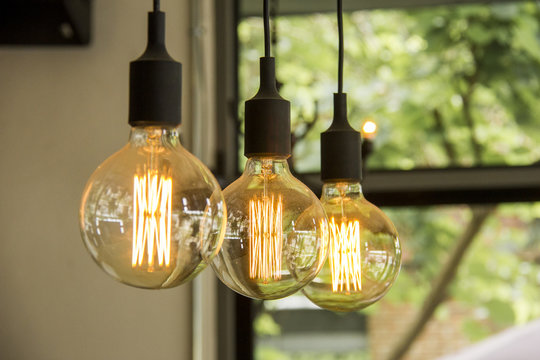 Glowing retro light bulbs hanging from ceiling