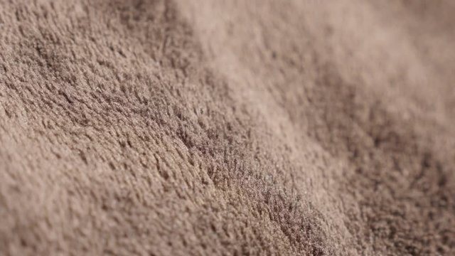 Brown polar polyester fleece warm fabric texture 4K 2160p 30fps UltraHD tilting footage - Slow tilt over dark synthetic fibers of polar blanket close-up 4K 3840X2160 UHD video 