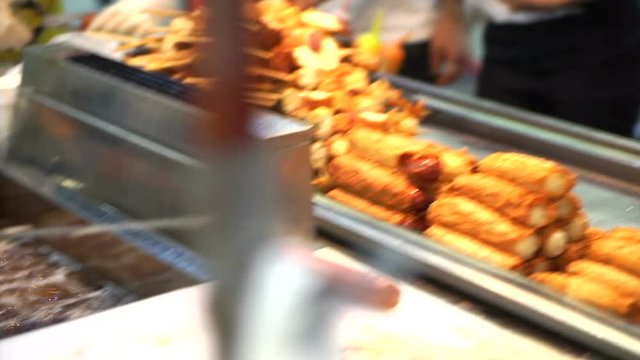 Eomuk, Korean street food. Fried fish cake, sausage and hot dog on stick with red sauce in Seoul, Korea