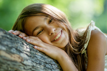 girl lying on a tree