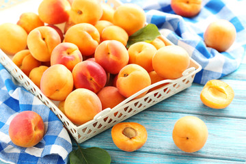 Ripe apricots fruit on blue wooden table