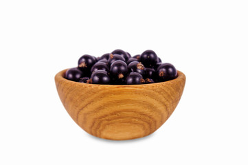 black currant in a wooden bowl. Ripe and tasty currant isolated