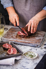 Barbecue Roast Beef muscle cut for person over grey cutting board.