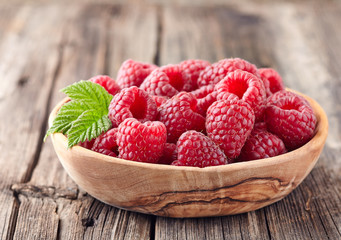 Raspberry in wooden plate