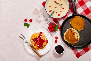 Pancakes with Raspberry Sauce for breakfast. Selective focus.