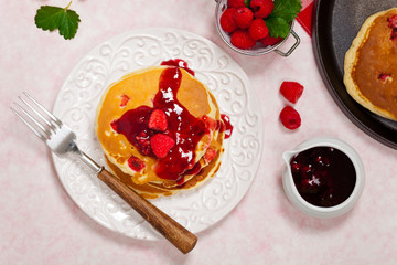 Pancakes with Raspberry Sauce for breakfast. Selective focus.