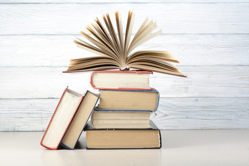 Open book, hardback books on wooden table. Education background. Back to school. Copy space for text.