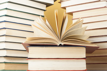 Open book, hardback books on wooden table. Education background. Back to school. Copy space for text.