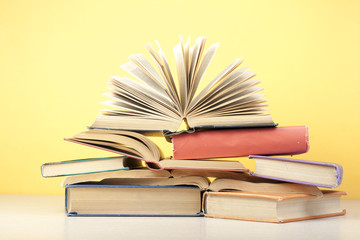 Open book, hardback books on wooden table. Education background. Back to school. Copy space for text.