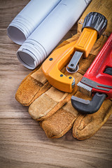 Construction drawings safety gloves monkey wrench pipe cutter on