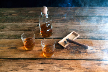 Obraz na płótnie Canvas Whisky with ice and cigar on wooden table