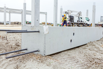 Giant reinforced concrete column is placed on sandy ground