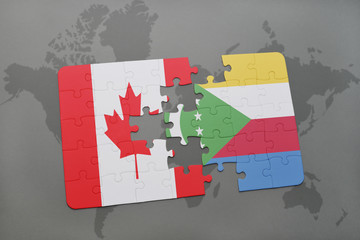 puzzle with the national flag of canada and comoros on a world map background.