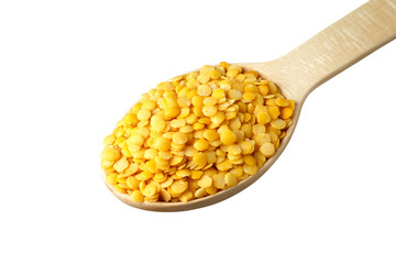 Yellow lentil in a wooden spoon
