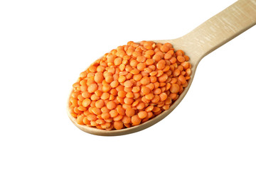 Red lentil in a wooden spoon