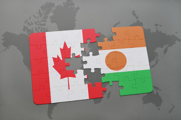 puzzle with the national flag of canada and niger on a world map background.