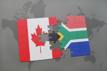 puzzle with the national flag of canada and south africa on a world map background.