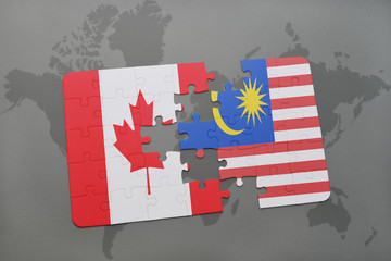 puzzle with the national flag of canada and malaysia on a world map background.