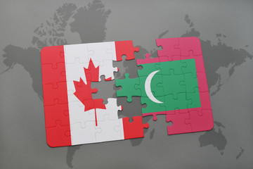 puzzle with the national flag of canada and maldives on a world map background.