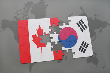 puzzle with the national flag of canada and south korea on a world map background.