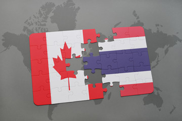 puzzle with the national flag of canada and thailand on a world map background.