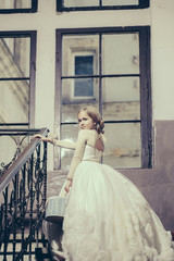 Fototapeta premium small girl in white dress near big window